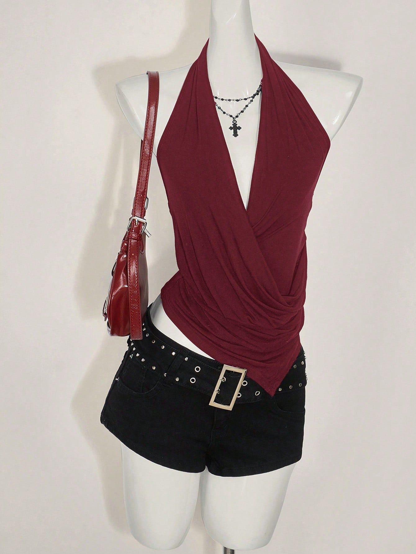 Women's asymmetrical hem halter tank top with draped neckline, backless wrap styling, and grommet eyelet details