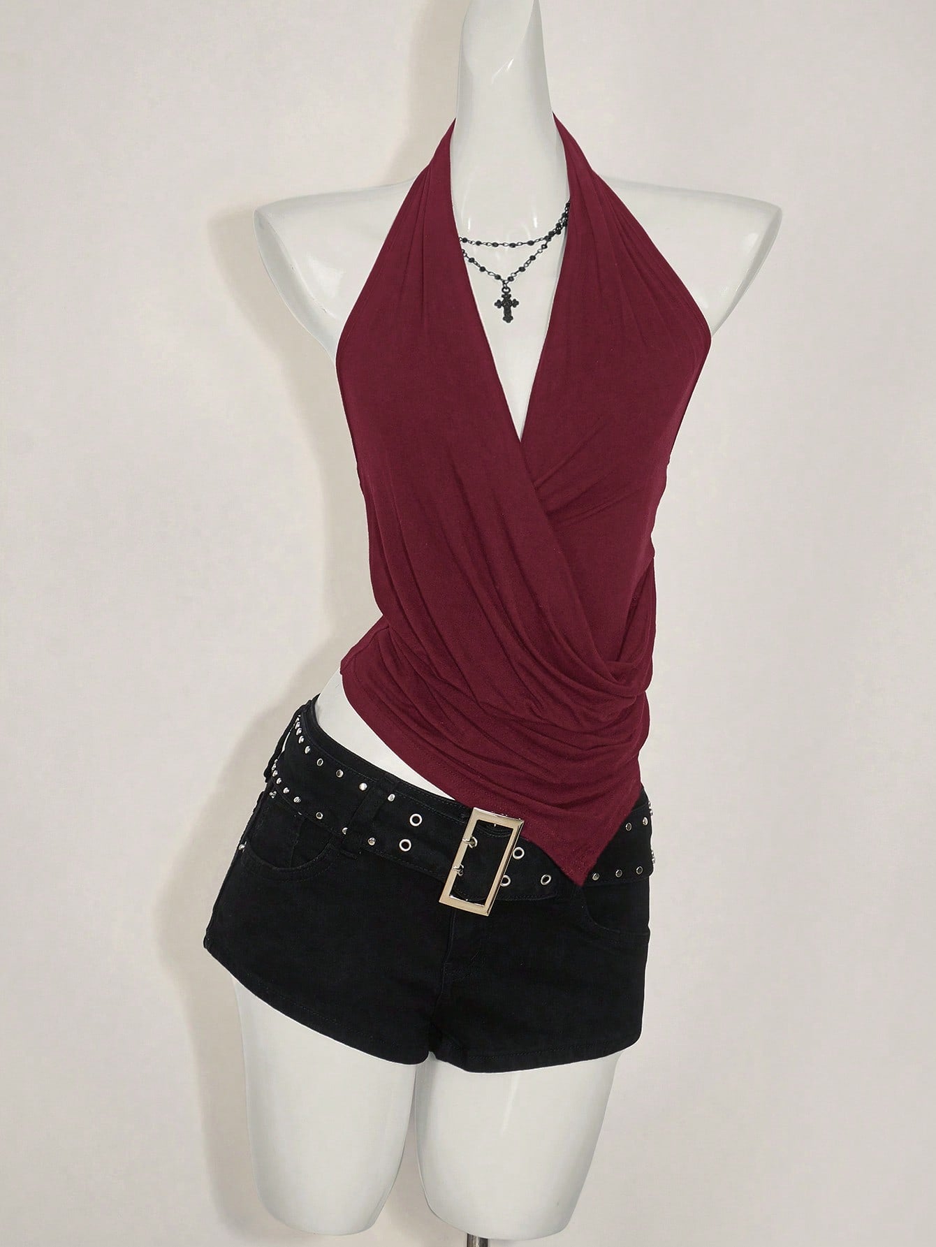 Women's asymmetrical hem halter tank top with draped neckline, backless wrap styling, and grommet eyelet details