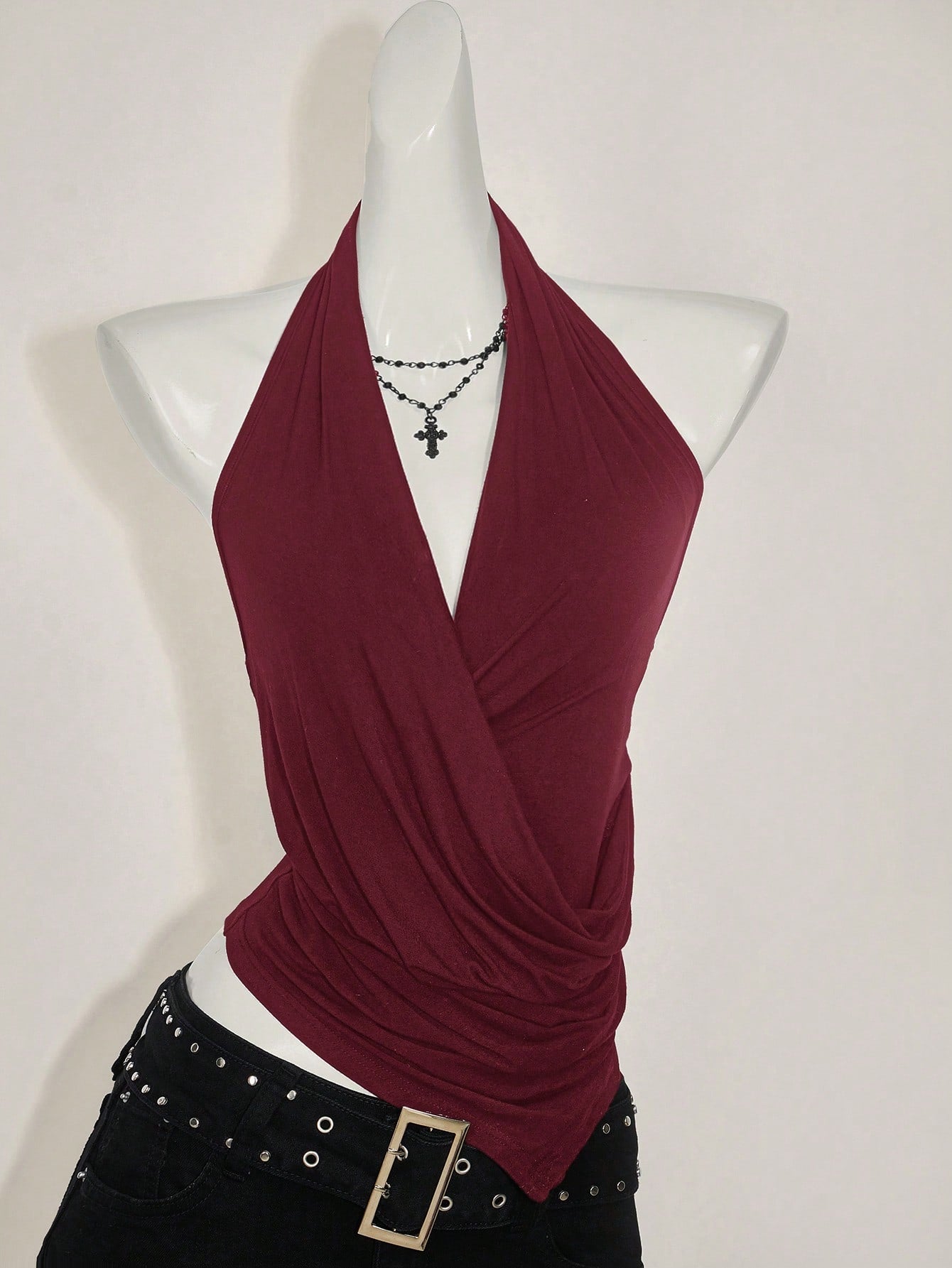 Women's asymmetrical hem halter tank top with draped neckline, backless wrap styling, and grommet eyelet details
