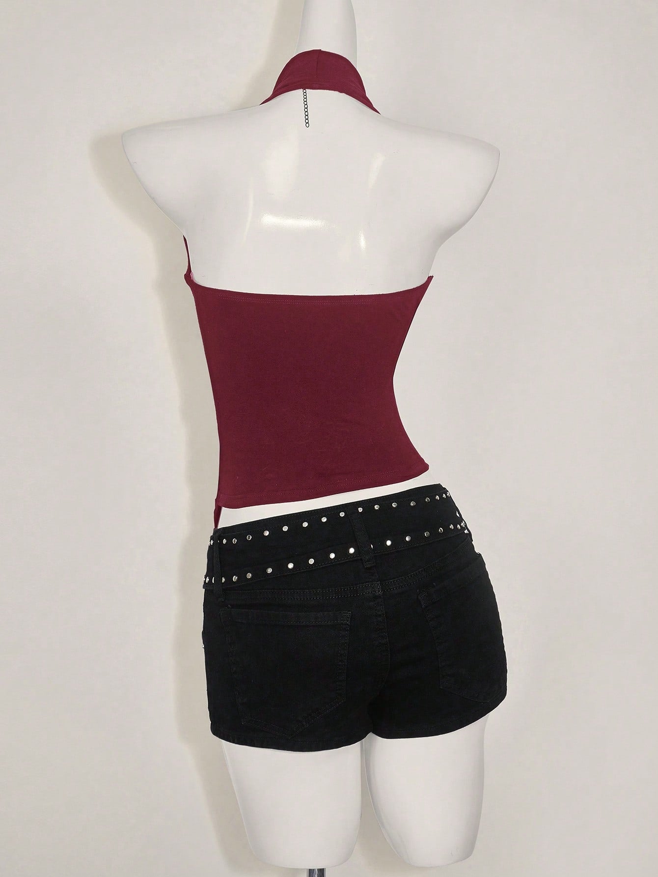 Women's asymmetrical hem halter tank top with draped neckline, backless wrap styling, and grommet eyelet details
