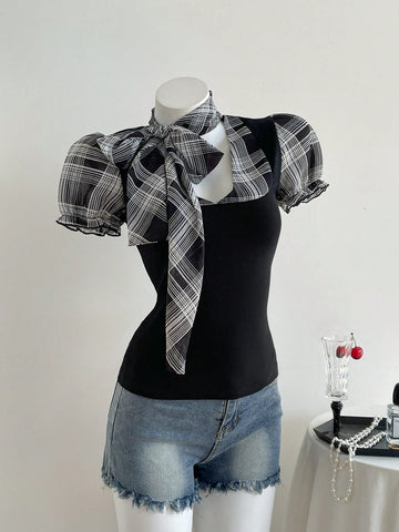 Women's slim fit short sleeve t-shirt featuring puff sleeves, Queen Anne neckline, tie-up front knot, frill detail, and raw hem.