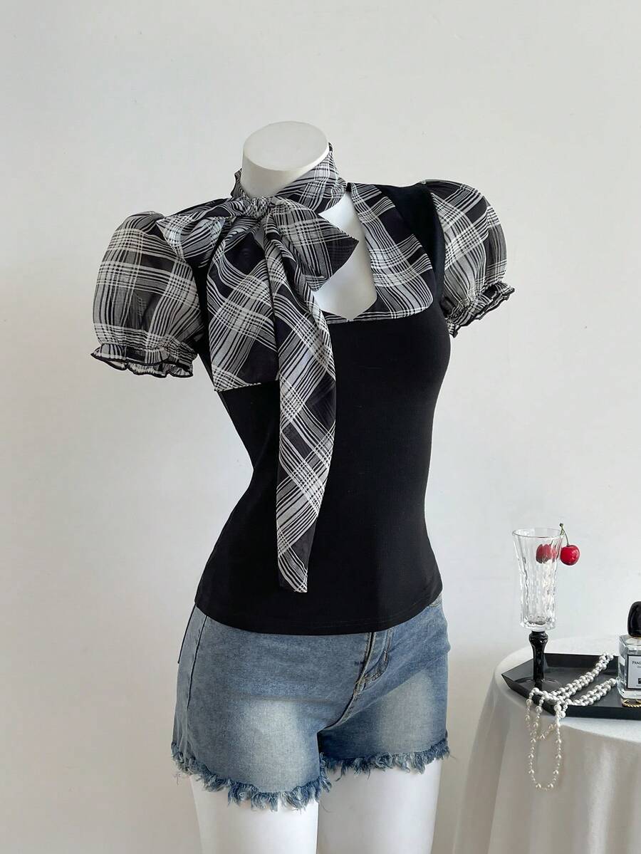 Women's slim fit short sleeve t-shirt featuring puff sleeves, Queen Anne neckline, tie-up front knot, frill detail, and raw hem.