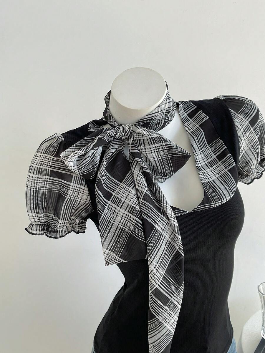 Women's slim fit short sleeve t-shirt featuring puff sleeves, Queen Anne neckline, tie-up front knot, frill detail, and raw hem.