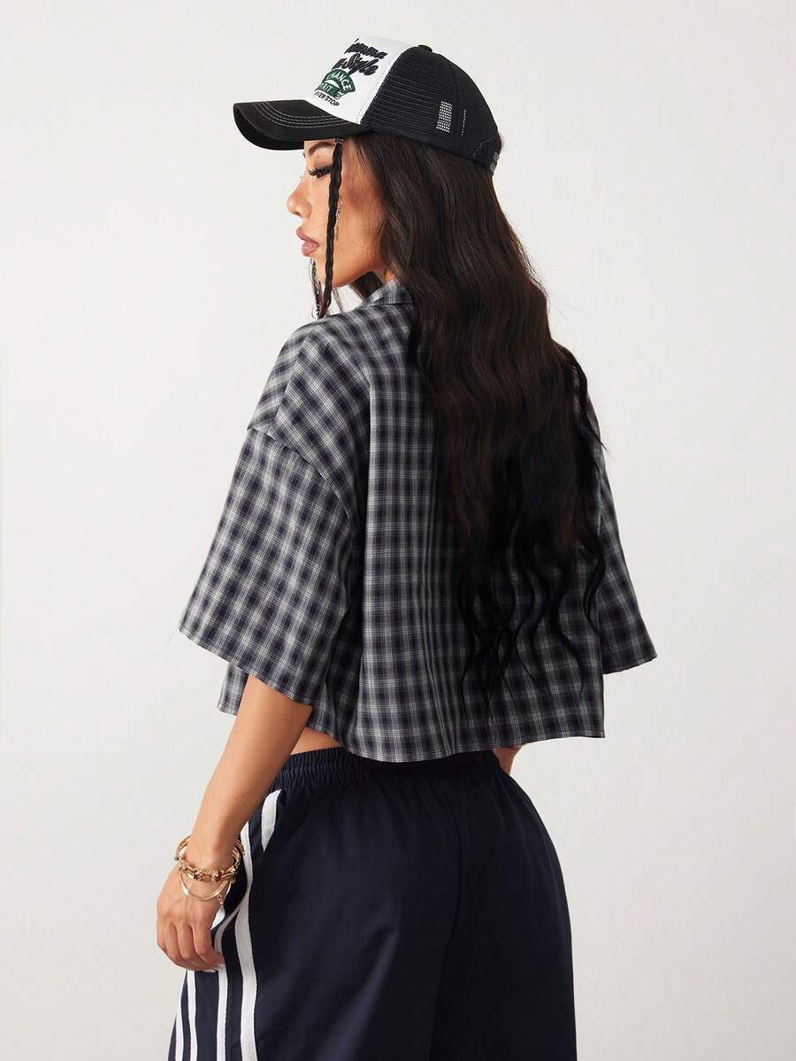 Women's plaid crop shirt with button front, chest pocket, short sleeves, and loose casual fit.
