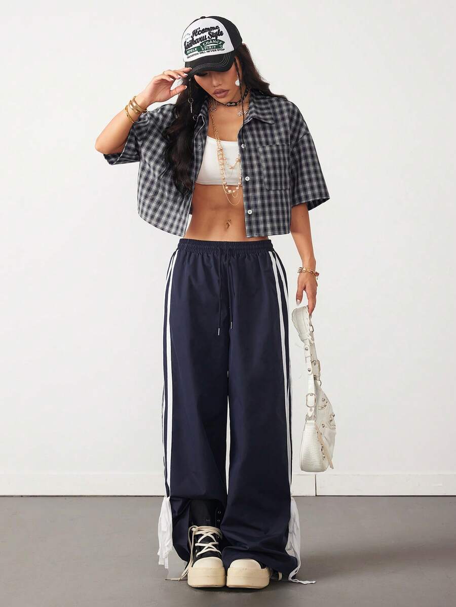 Women's plaid crop shirt with button front, chest pocket, short sleeves, and loose casual fit.