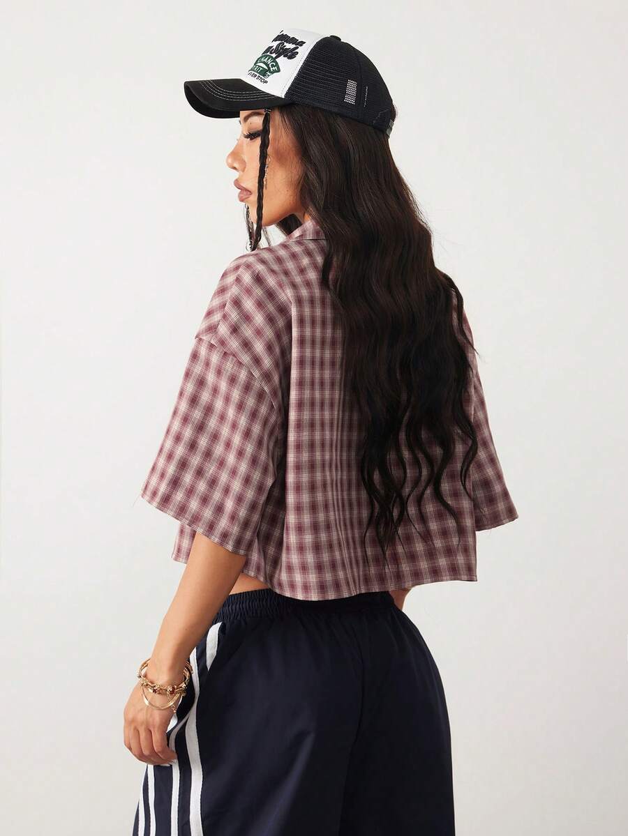Women's plaid crop shirt with button front, chest pocket, short sleeves, and loose casual fit.