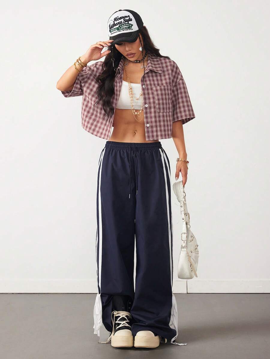 Women's plaid crop shirt with button front, chest pocket, short sleeves, and loose casual fit.