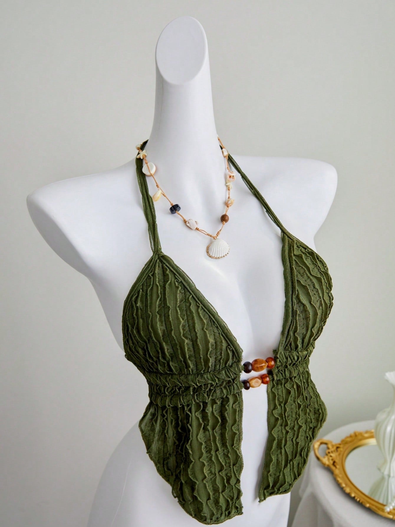 Women's textured halter camisole with pearl bead details, backless styling, asymmetrical hem, and micro crop slim fit