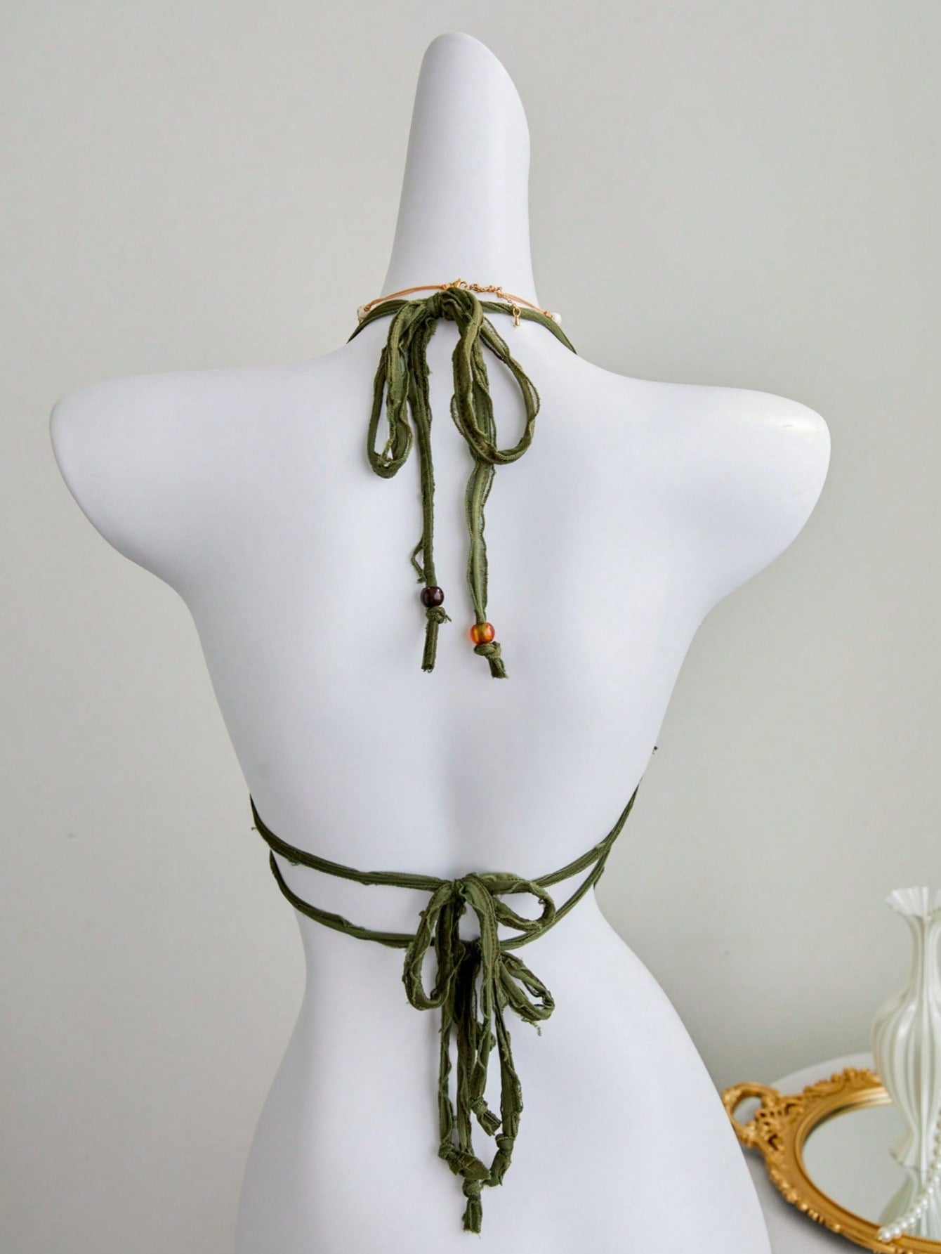 Women's textured halter camisole with pearl bead details, backless styling, asymmetrical hem, and micro crop slim fit