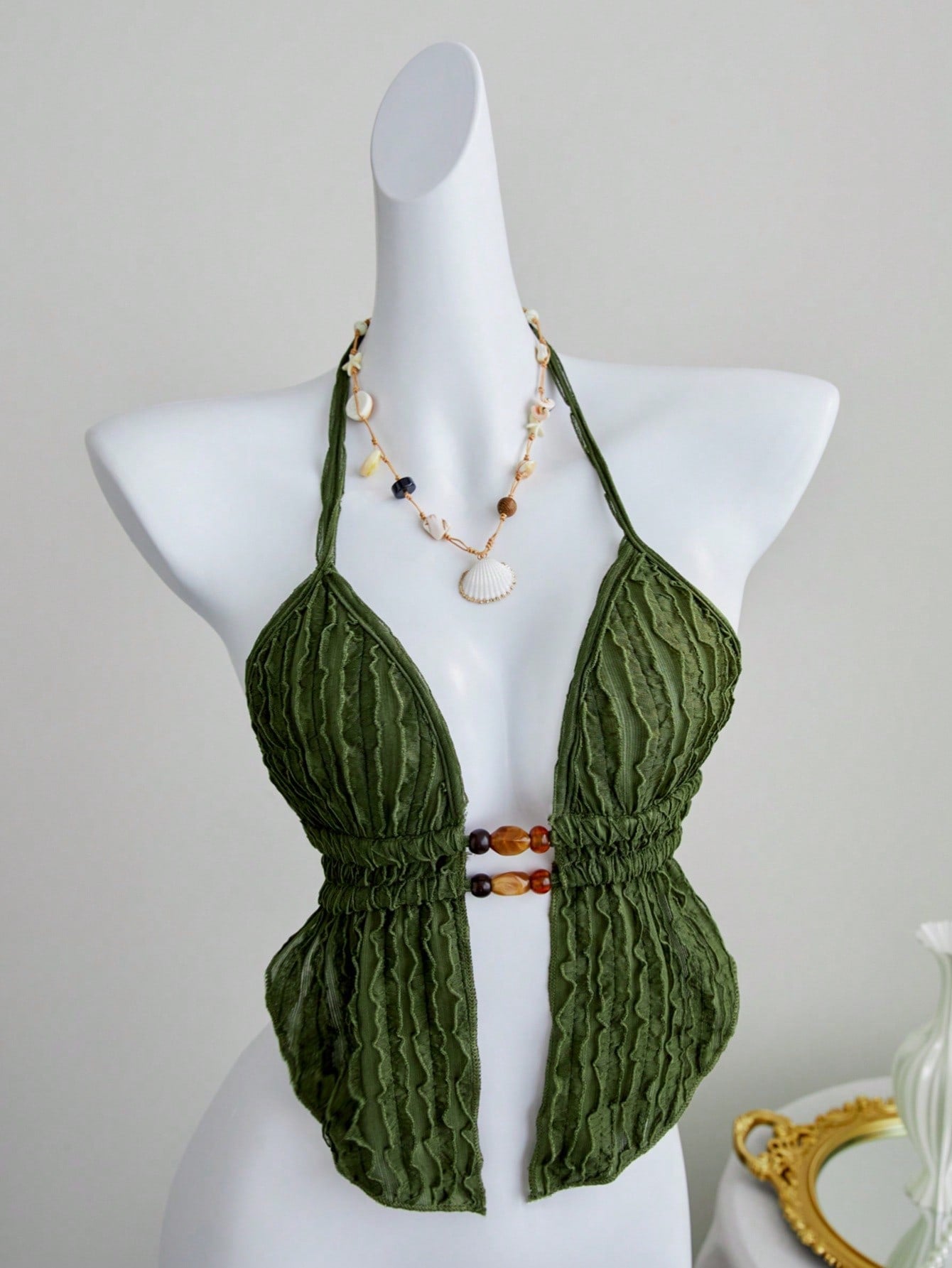 Women's textured halter camisole with pearl bead details, backless styling, asymmetrical hem, and micro crop slim fit