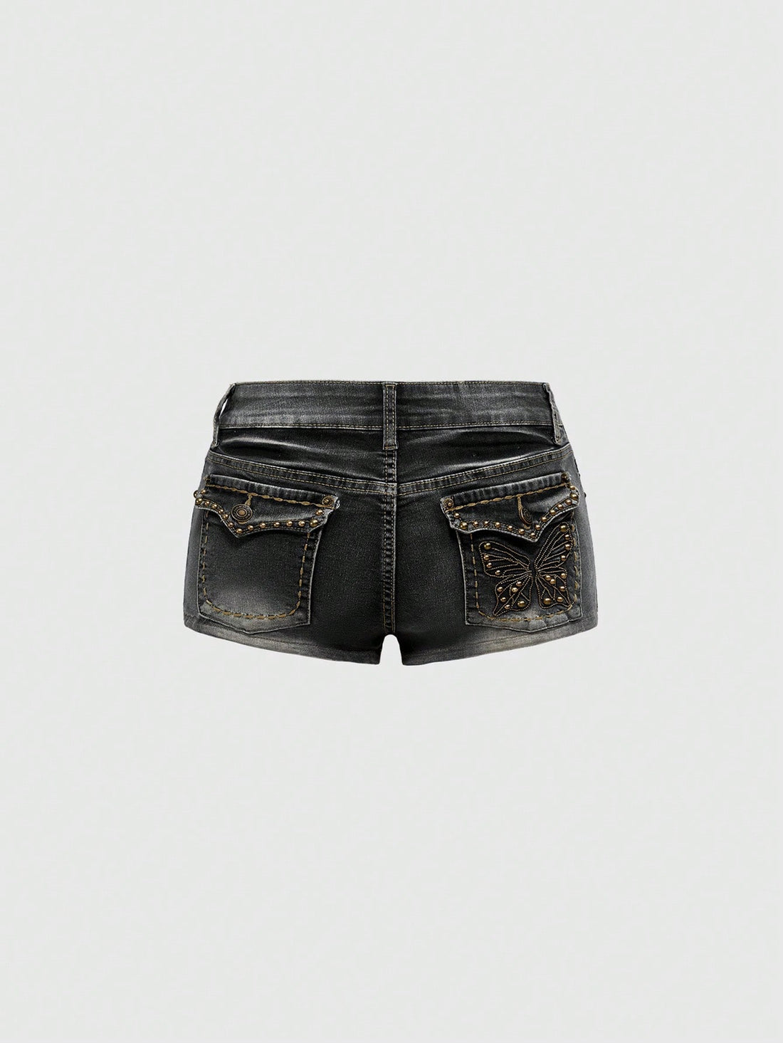 Women's Y2K low waist distressed shorts featuring butterfly studded details, pockets, and a zipper fly closure.