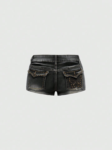 Women's Y2K low waist distressed shorts featuring butterfly studded details, pockets, and a zipper fly closure.