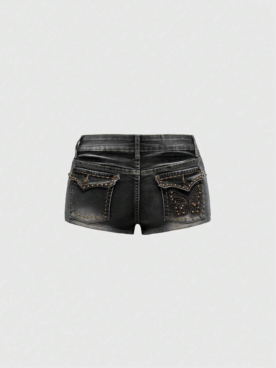 Women's Y2K low waist distressed shorts featuring butterfly studded details, pockets, and a zipper fly closure.