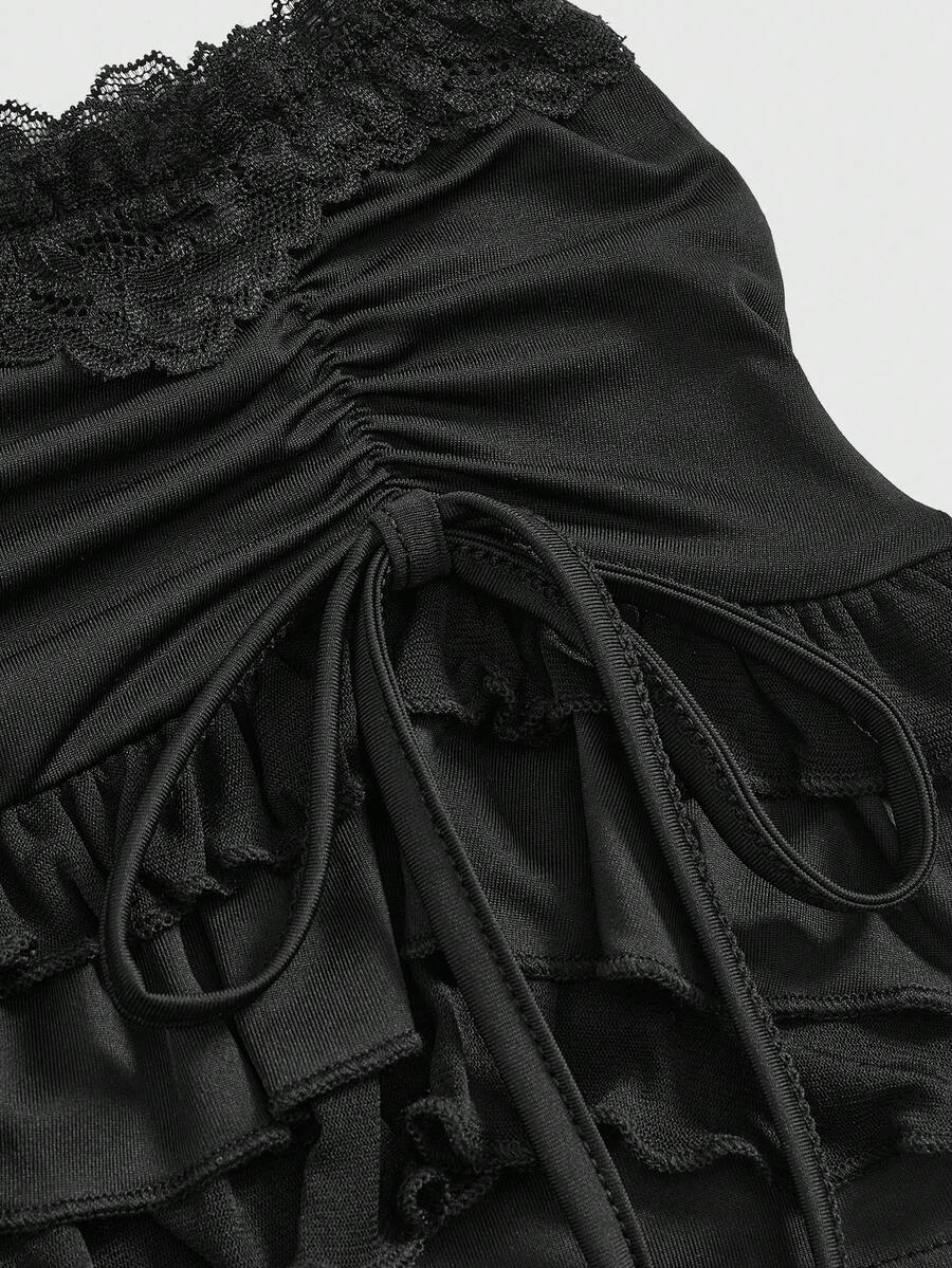 Women's black low-waist mini skirt with drawstring tie, ruched details, lace trim, layered ruffle hem, and asymmetric styling