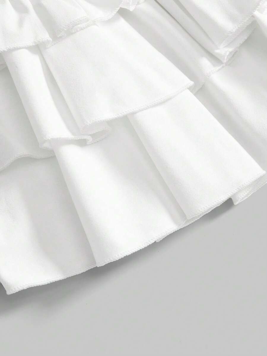 Women's low waist tiered mini skirt featuring ruffled hem layers in knitted stretch fabric.