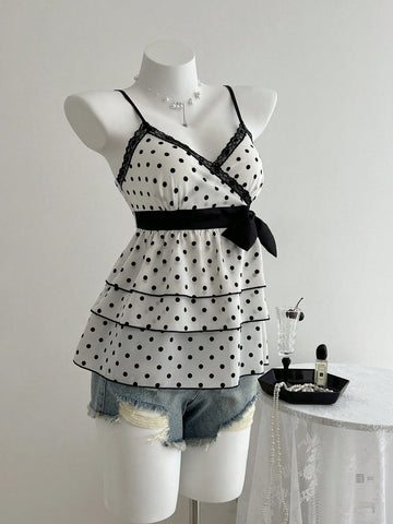 Women's polka dot camisole top with contrast lace trim, tank vest neckline, slim fit, and flared ruffle hem.