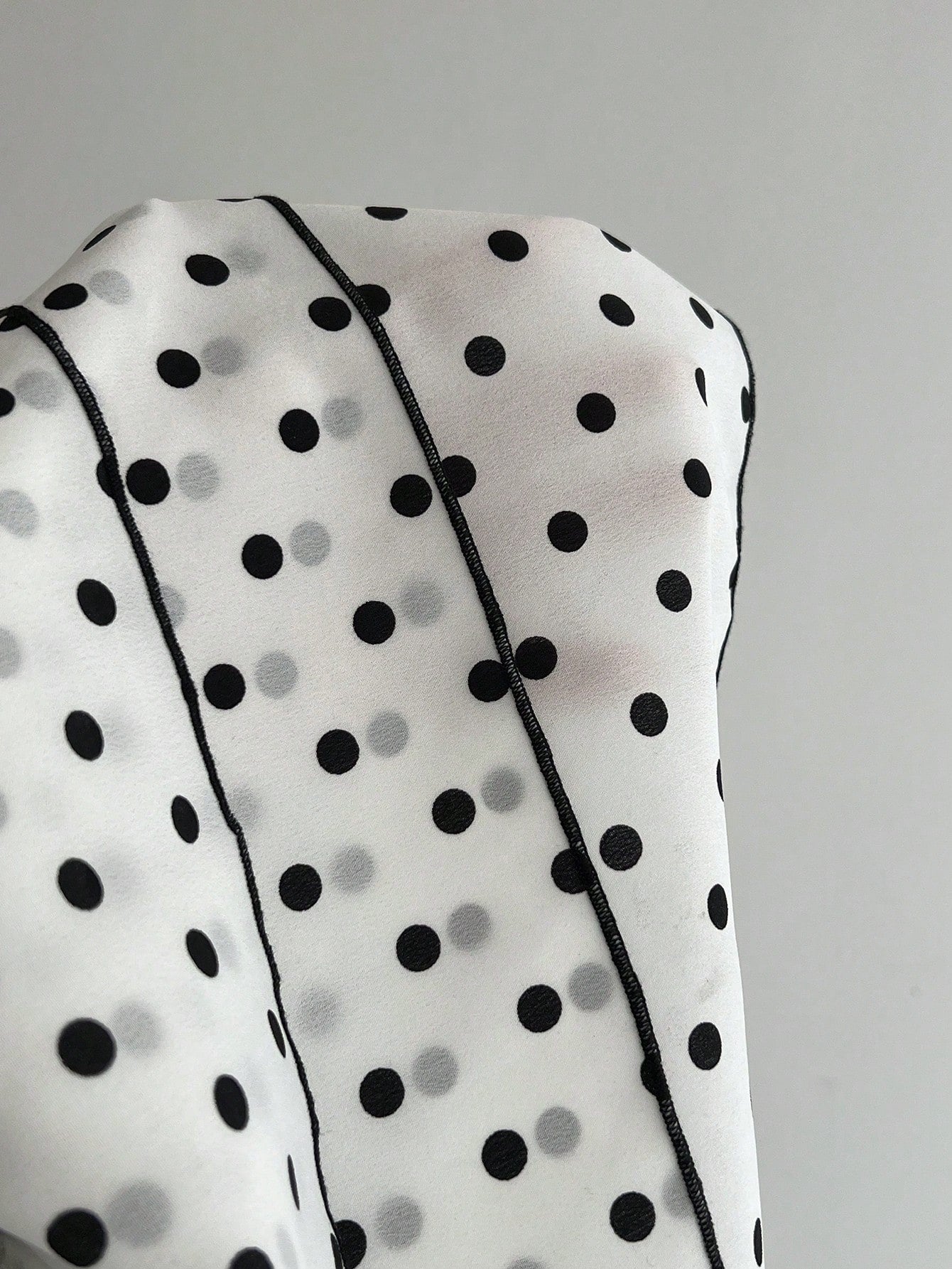 Women's polka dot camisole top with contrast lace trim, tank vest neckline, slim fit, and flared ruffle hem.