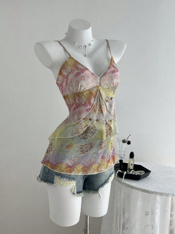 Women's boho spaghetti strap cami with multicolor all-over plant print, contrast lace detail, ruffle tiered hem, and slim fit silhouette.