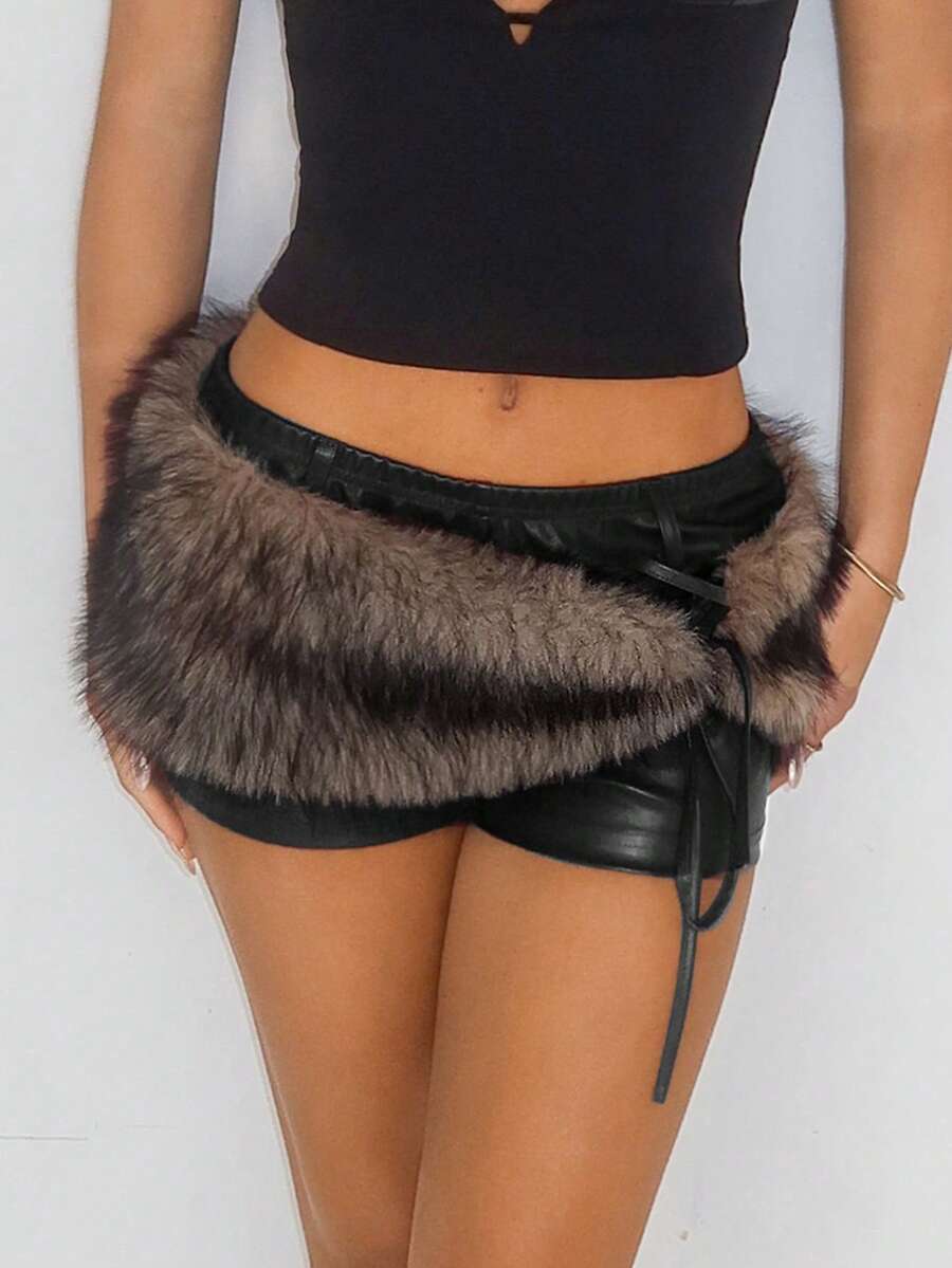 Women's brown low waist PU mini shorts with contrast faux fur panel, knot detail, zipper detail, and elastic waistband