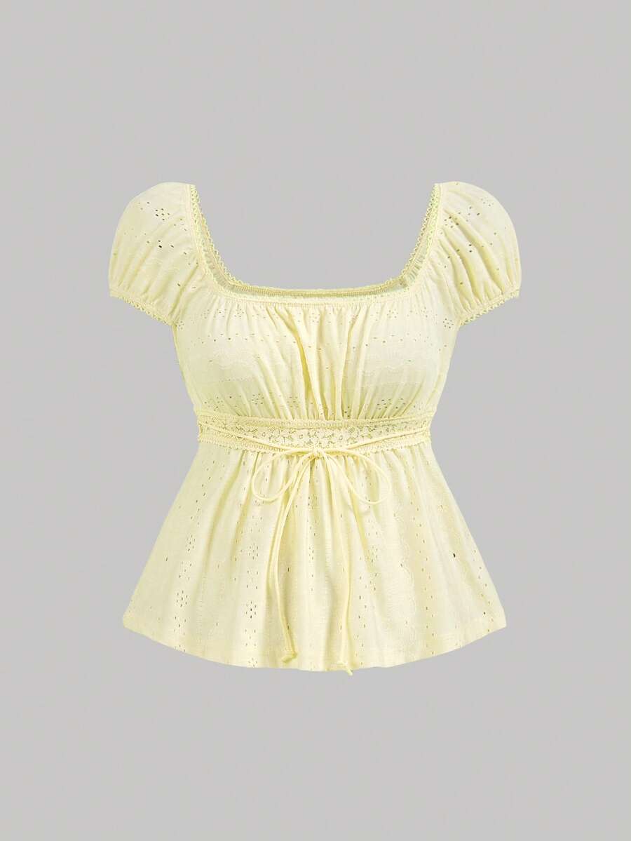 Yellow short puff sleeve tee featuring a square neckline, ruched bust with knot detail, eyelet embroidery, and a gathered waist.