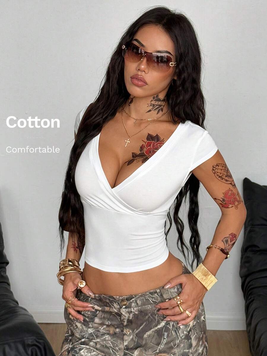 Women's slim fit V-neck short sleeve crop t-shirt featuring ruched wrap detailing in stretch knit fabric.