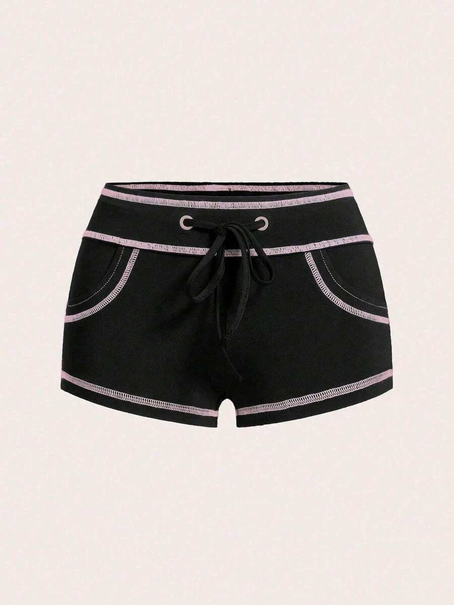 Women's low waist track shorts with drawstring waist, zipper detail, and mini length in a casual skinny fit