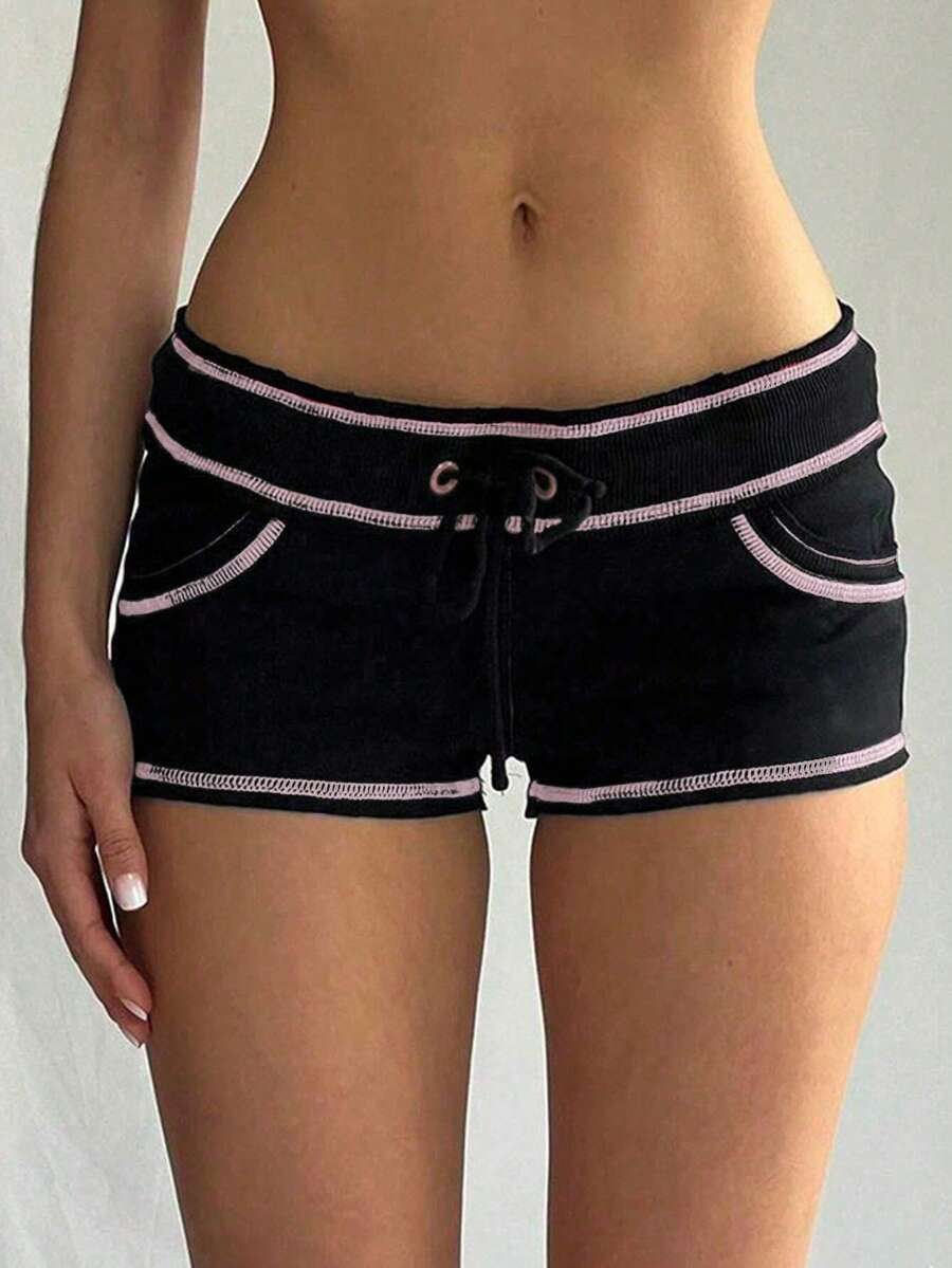 Women's low waist track shorts with drawstring waist, zipper detail, and mini length in a casual skinny fit