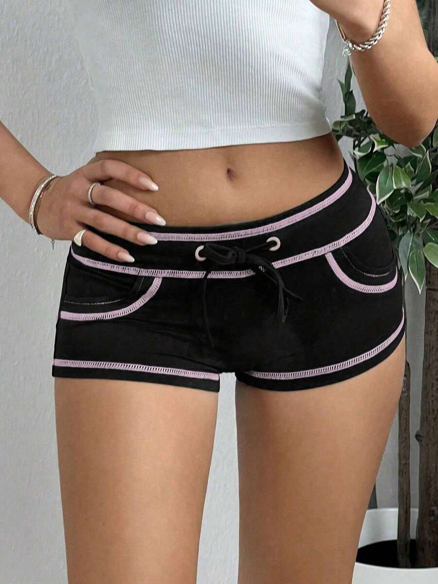 Women's low waist track shorts with drawstring waist, zipper detail, and mini length in a casual skinny fit