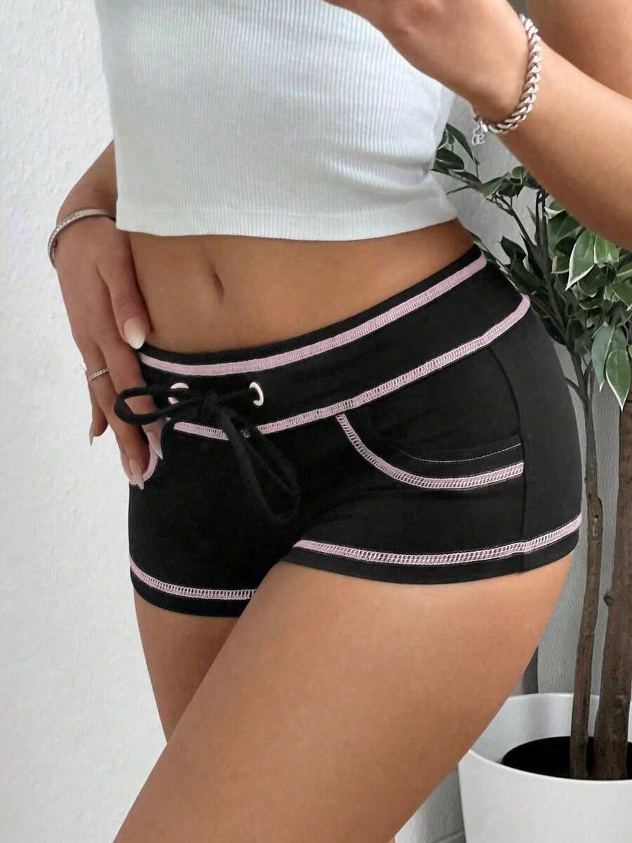 Women's low waist track shorts with drawstring waist, zipper detail, and mini length in a casual skinny fit