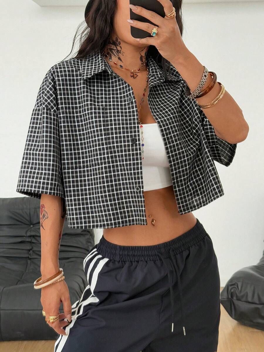 Women's plaid crop shirt with button front, chest pocket, short sleeves, and loose casual fit.