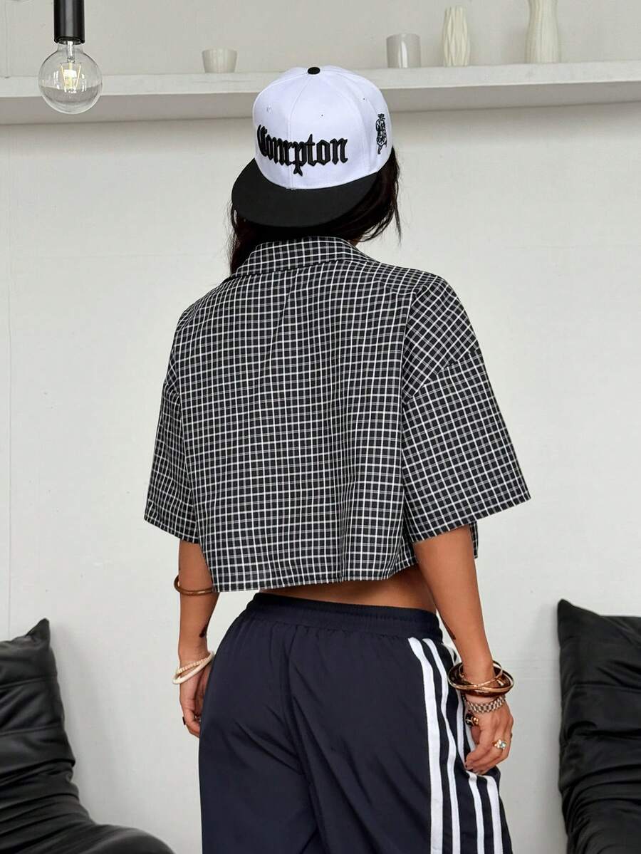 Women's plaid crop shirt with button front, chest pocket, short sleeves, and loose casual fit.