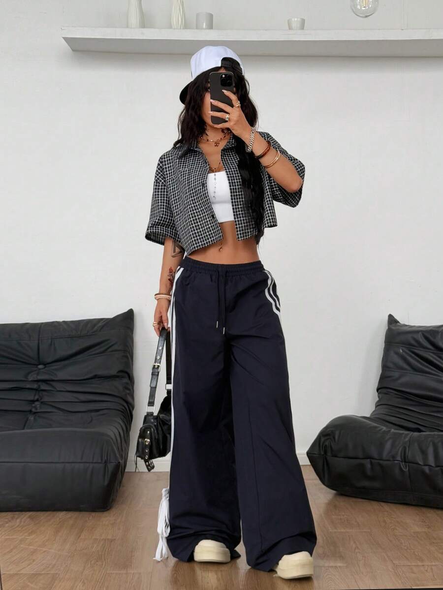Women's plaid crop shirt with button front, chest pocket, short sleeves, and loose casual fit.