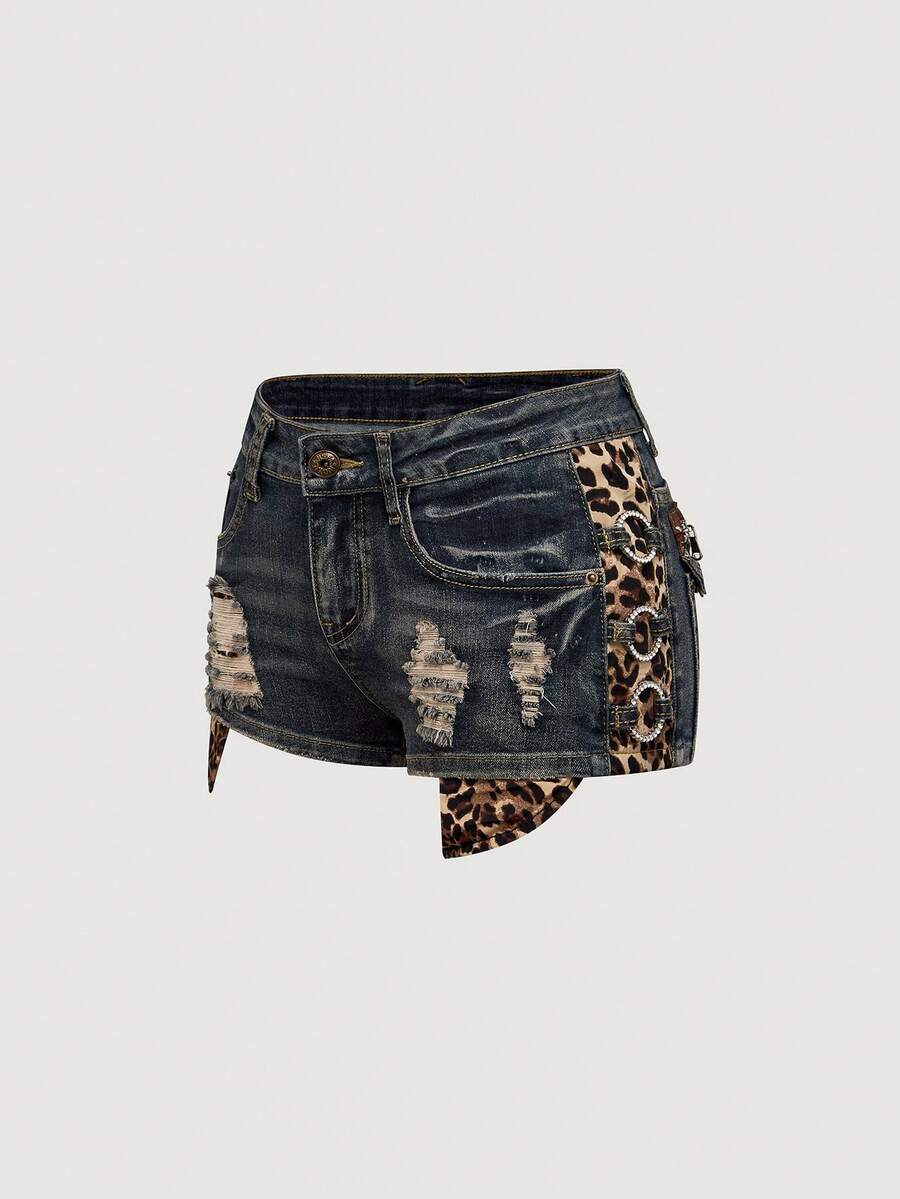 Women's ultra low waist vintage Y2K leopard print skinny mini shorts featuring ripped details, button, and zipper fly.