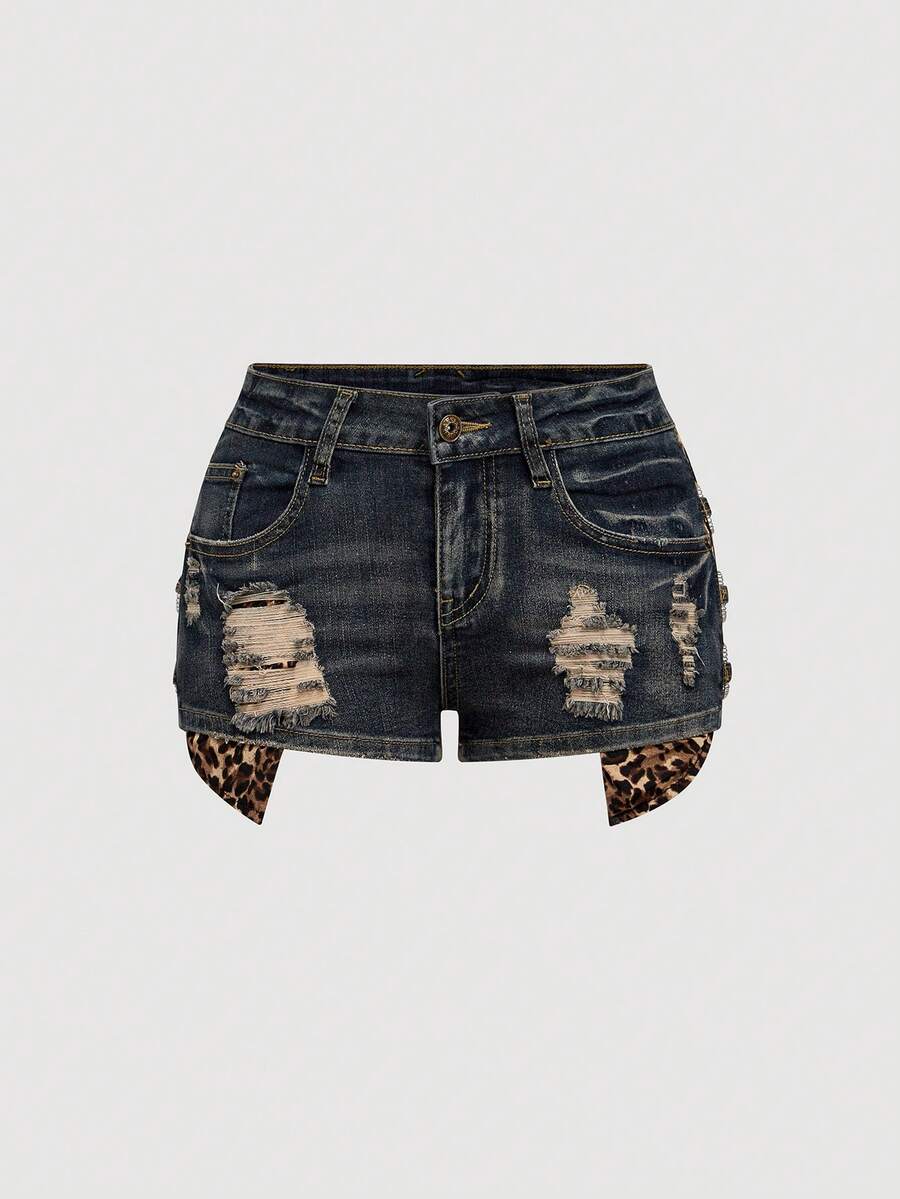 Women's ultra low waist vintage Y2K leopard print skinny mini shorts featuring ripped details, button, and zipper fly.