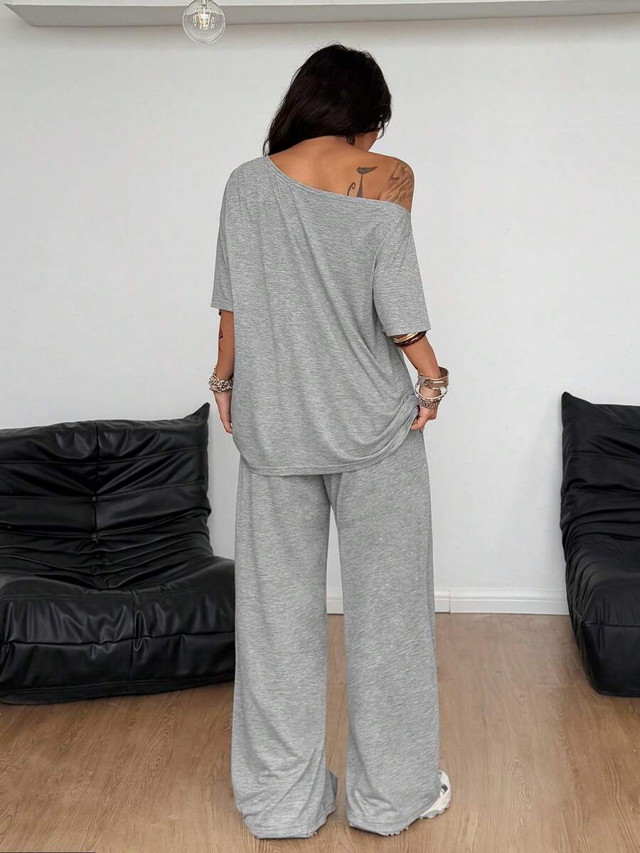 Women's two-piece outfit featuring an oversized asymmetrical neck t-shirt and matching wide-leg drawstring sweatpants.