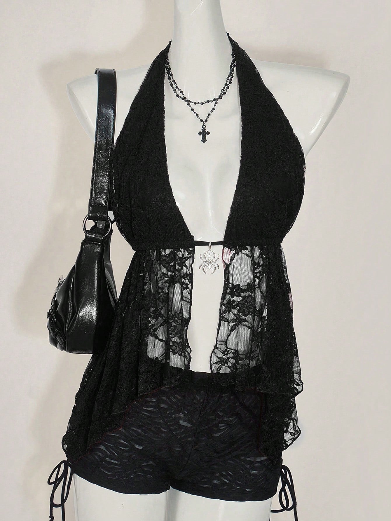 Women's lace halter neck camisole with backless styling, asymmetrical hem, slim fit, and semi-sheer lined design