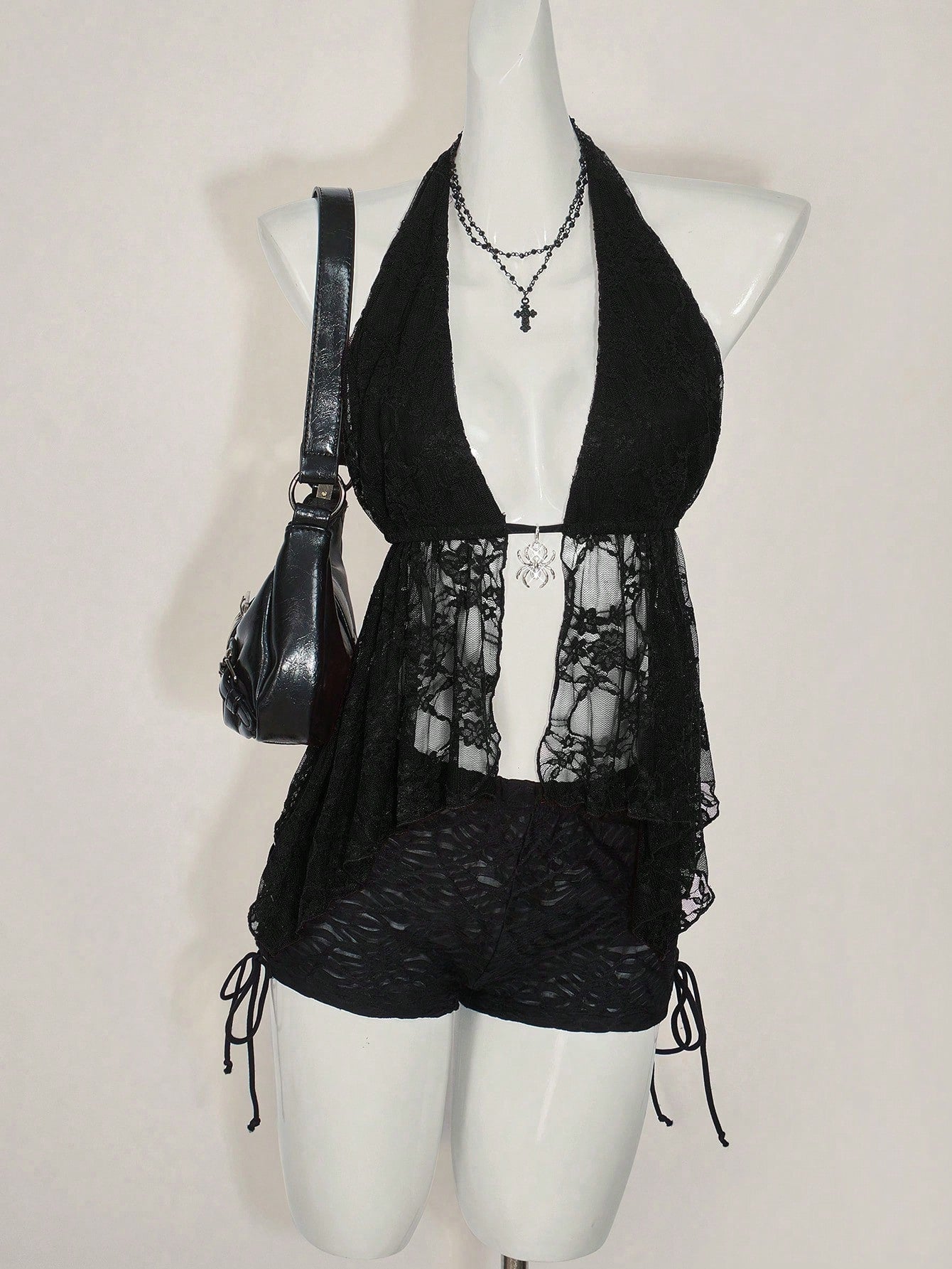 Women's lace halter neck camisole with backless styling, asymmetrical hem, slim fit, and semi-sheer lined design