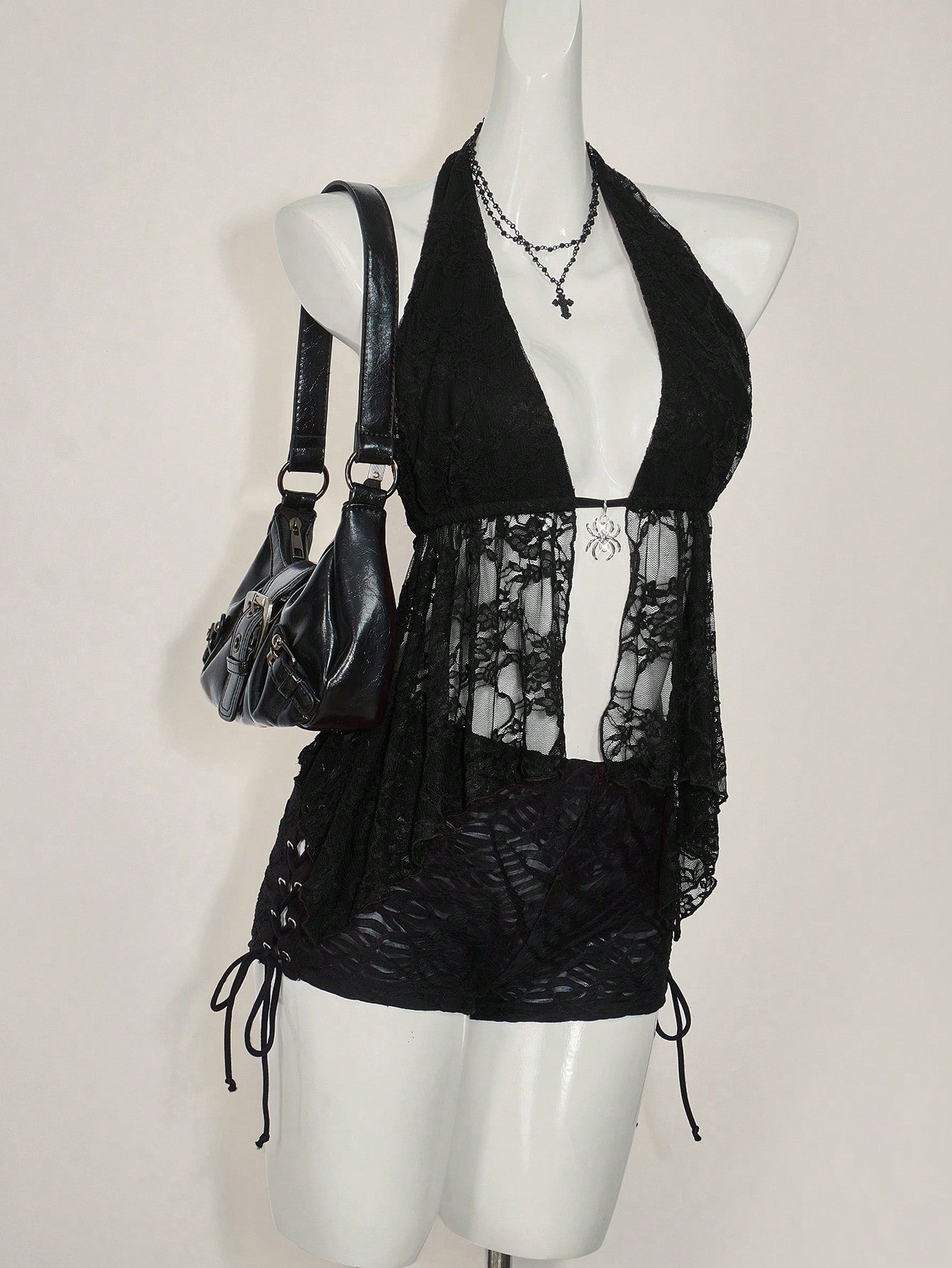 Women's lace halter neck camisole with backless styling, asymmetrical hem, slim fit, and semi-sheer lined design