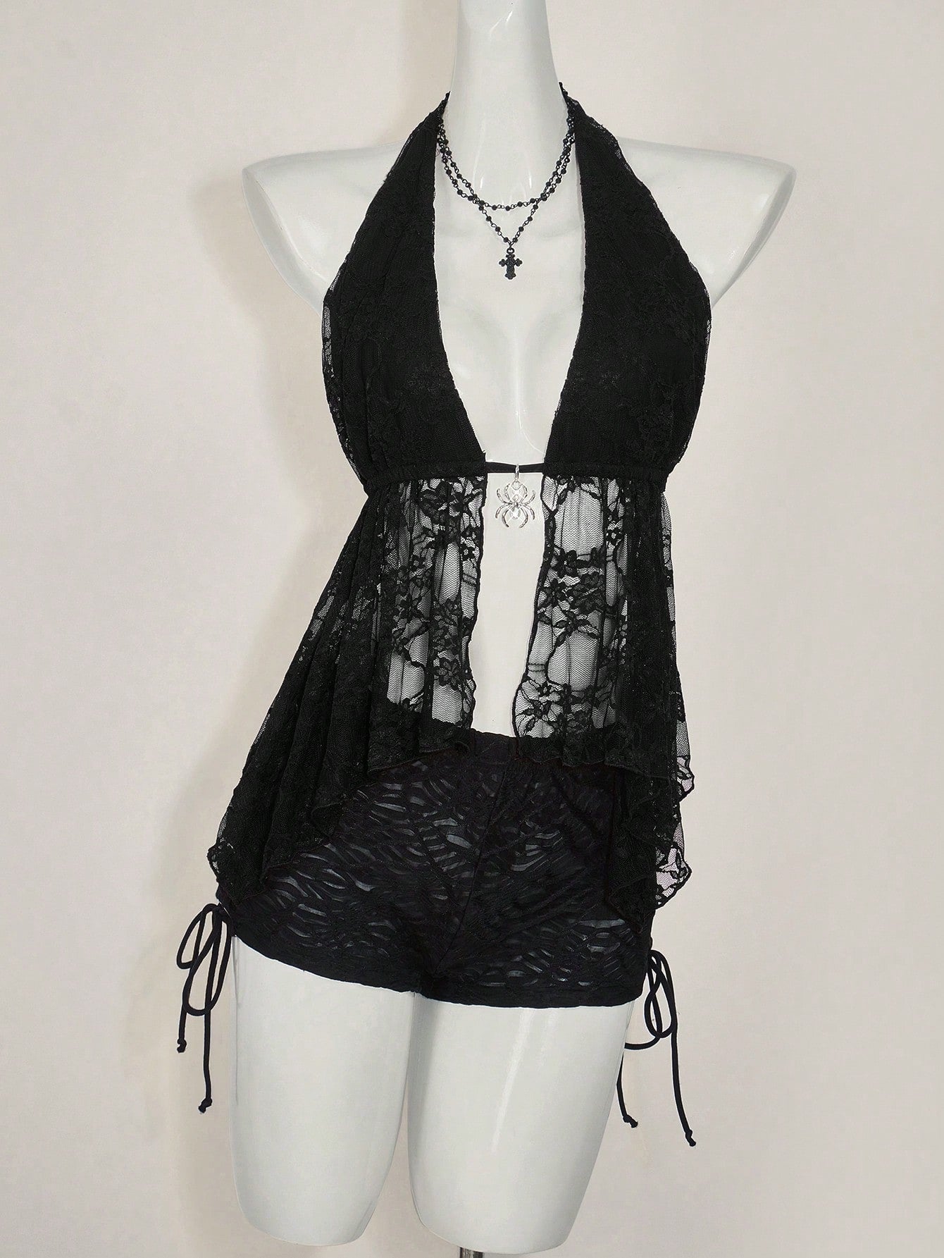 Women's lace halter neck camisole with backless styling, asymmetrical hem, slim fit, and semi-sheer lined design