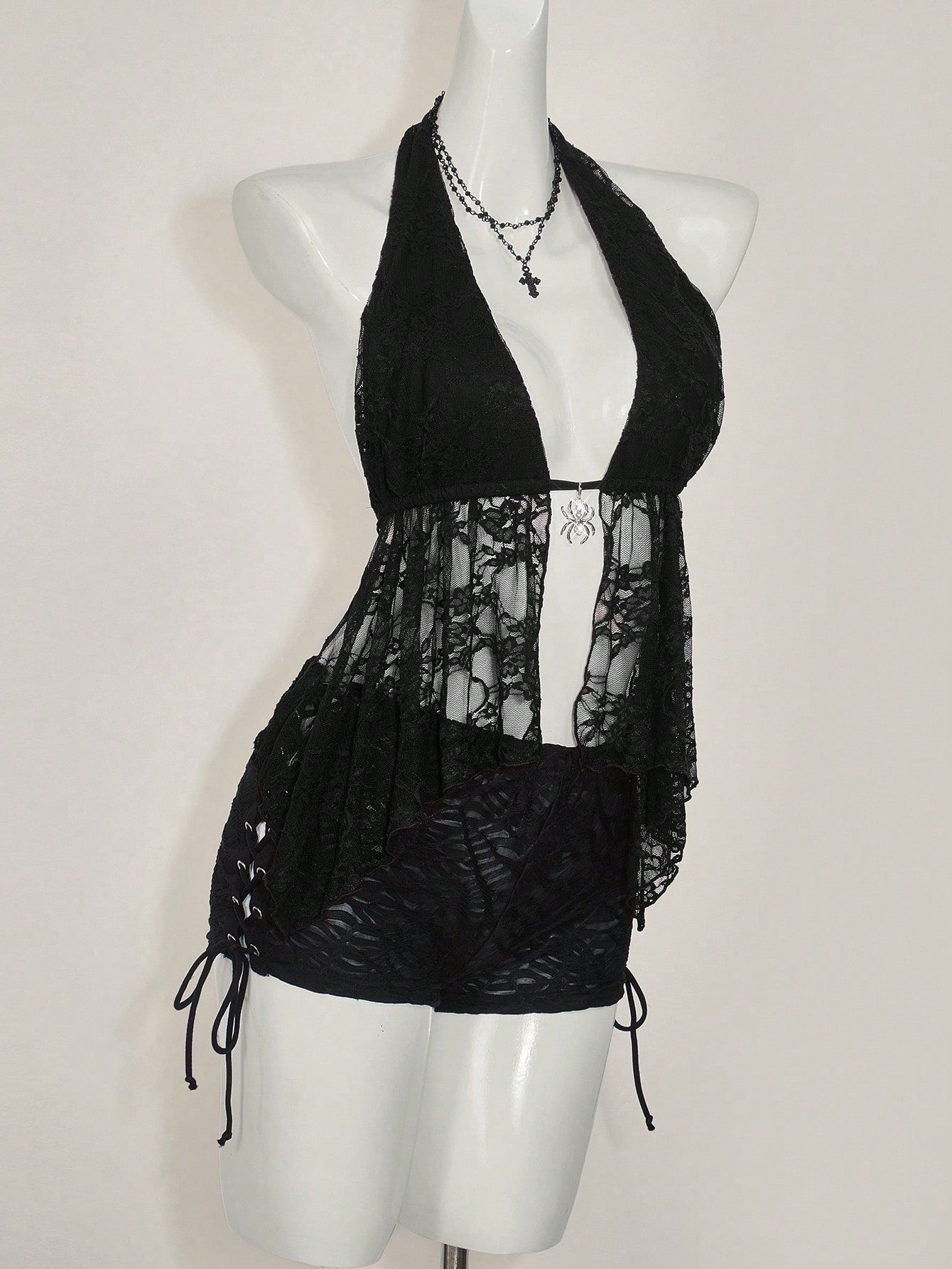 Women's lace halter neck camisole with backless styling, asymmetrical hem, slim fit, and semi-sheer lined design