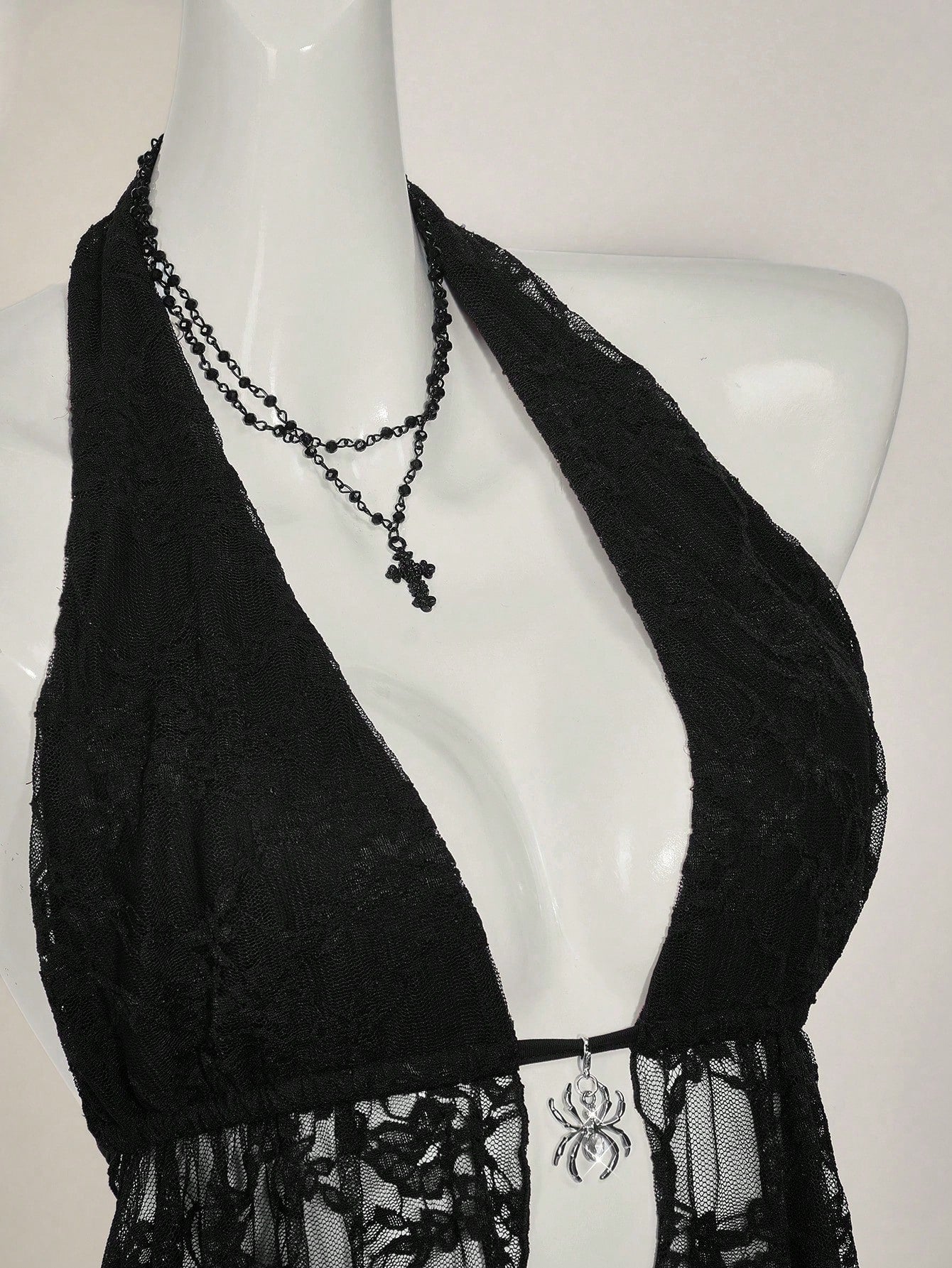 Women's lace halter neck camisole with backless styling, asymmetrical hem, slim fit, and semi-sheer lined design