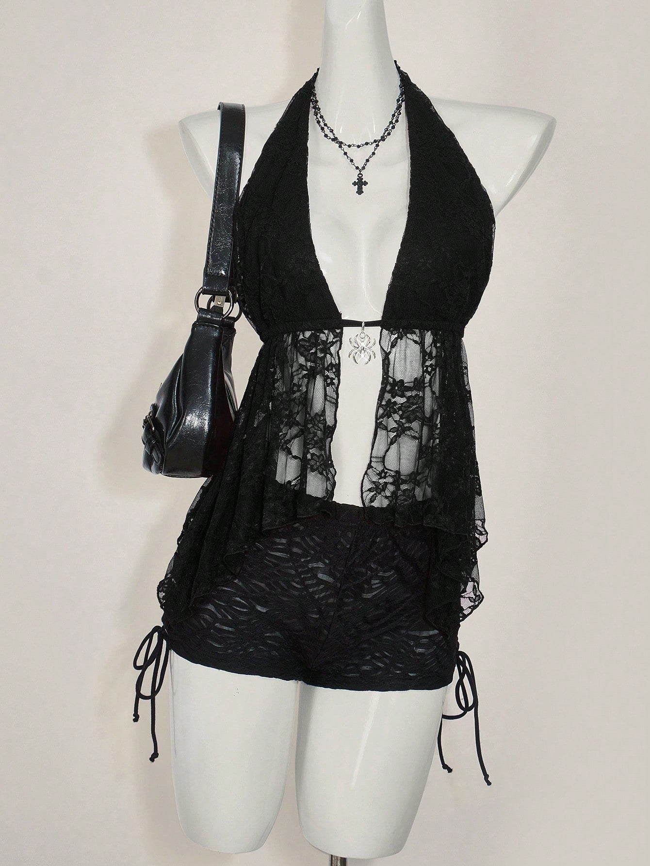 Women's lace halter neck camisole with backless styling, asymmetrical hem, slim fit, and semi-sheer lined design