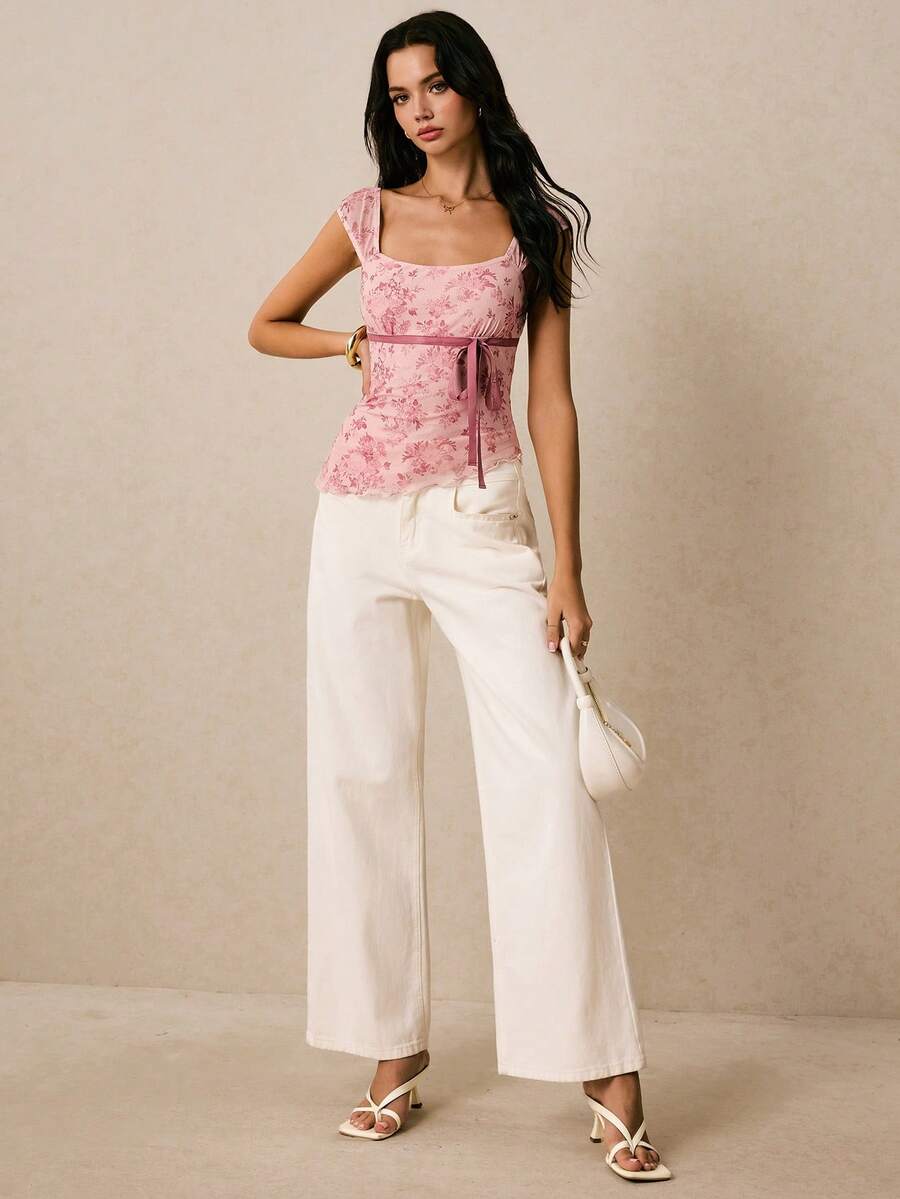 Women's dusty pink floral print mesh tank top featuring a square neckline, ruched bust with a tie-front knot, and an asymmetrical hem.