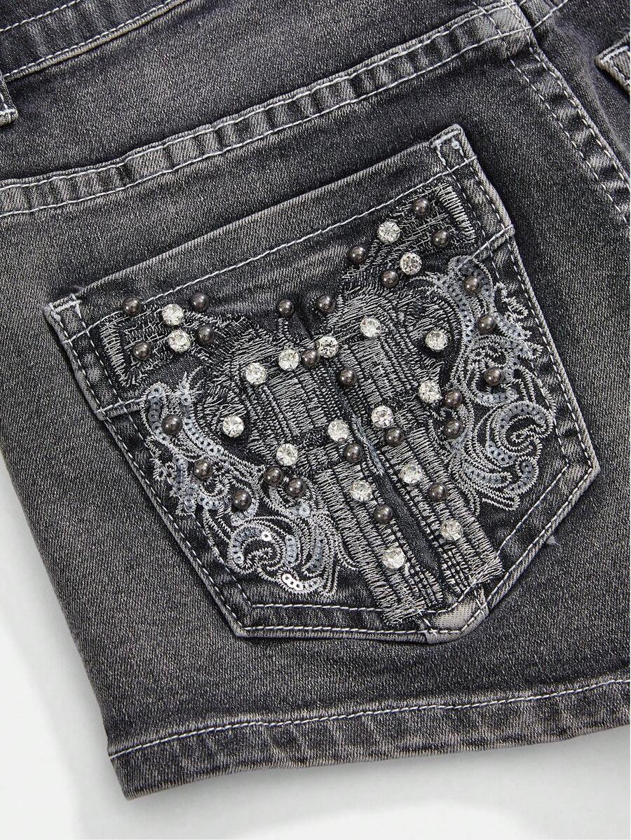 Women's ultra low waist skort with mini shorts length, zipper fly, pockets, pistol embroidery, and rhinestone details