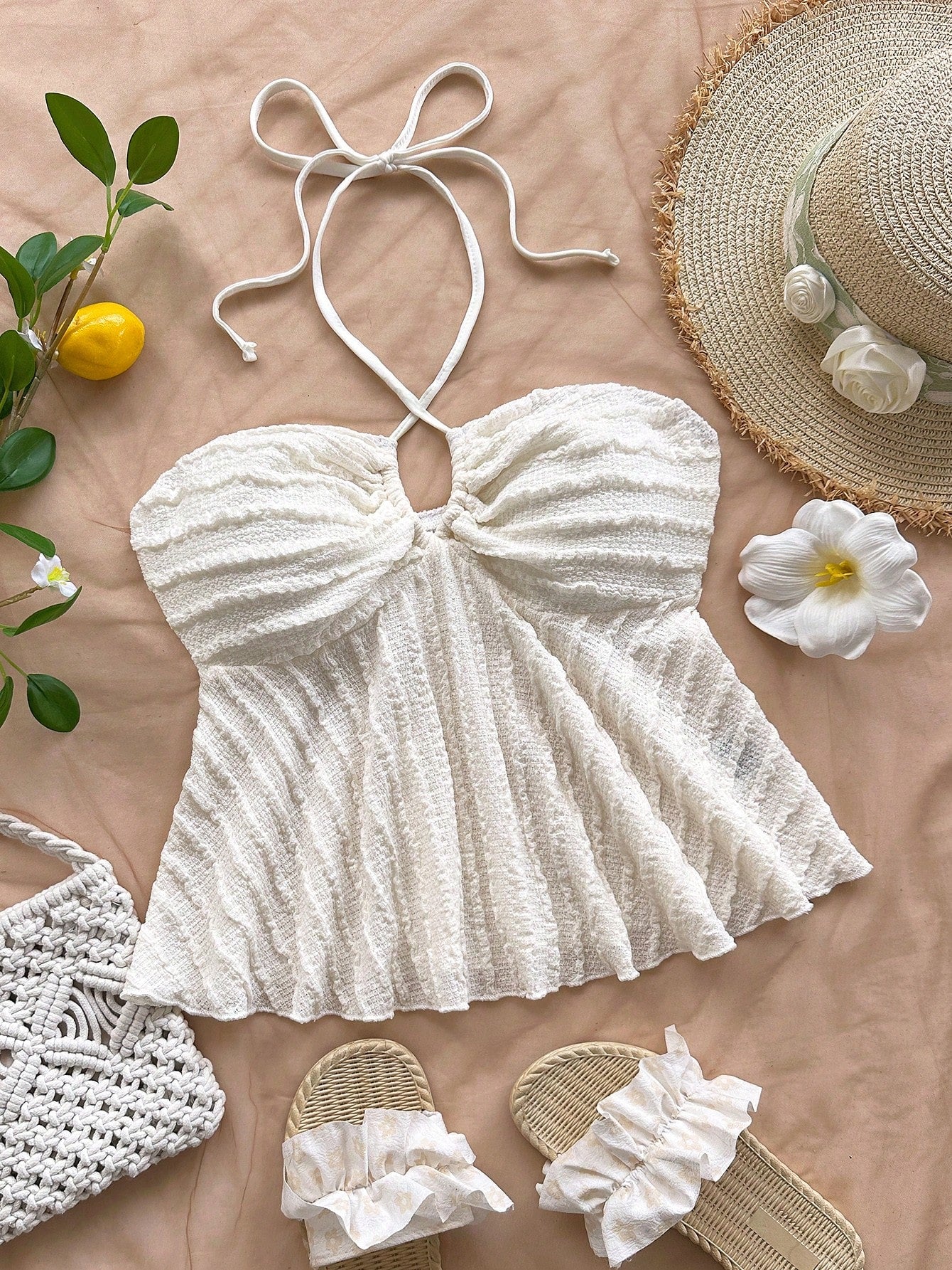 Women's textured V-neck halter tank top with backless knot detail, ruffle hem, and flared silhouette for casual beach and vacation wear.