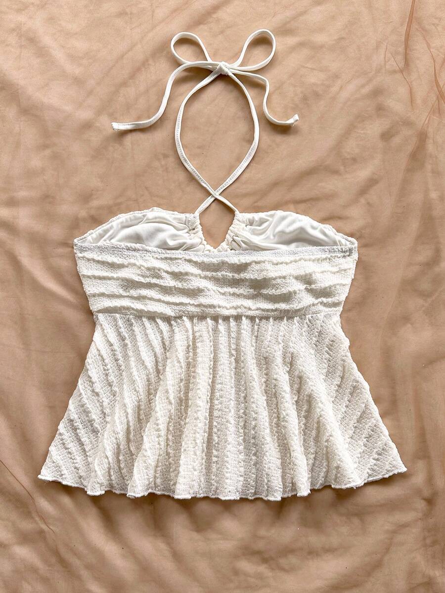 Women's textured V-neck halter tank top with backless knot detail, ruffle hem, and flared silhouette for casual beach and vacation wear.