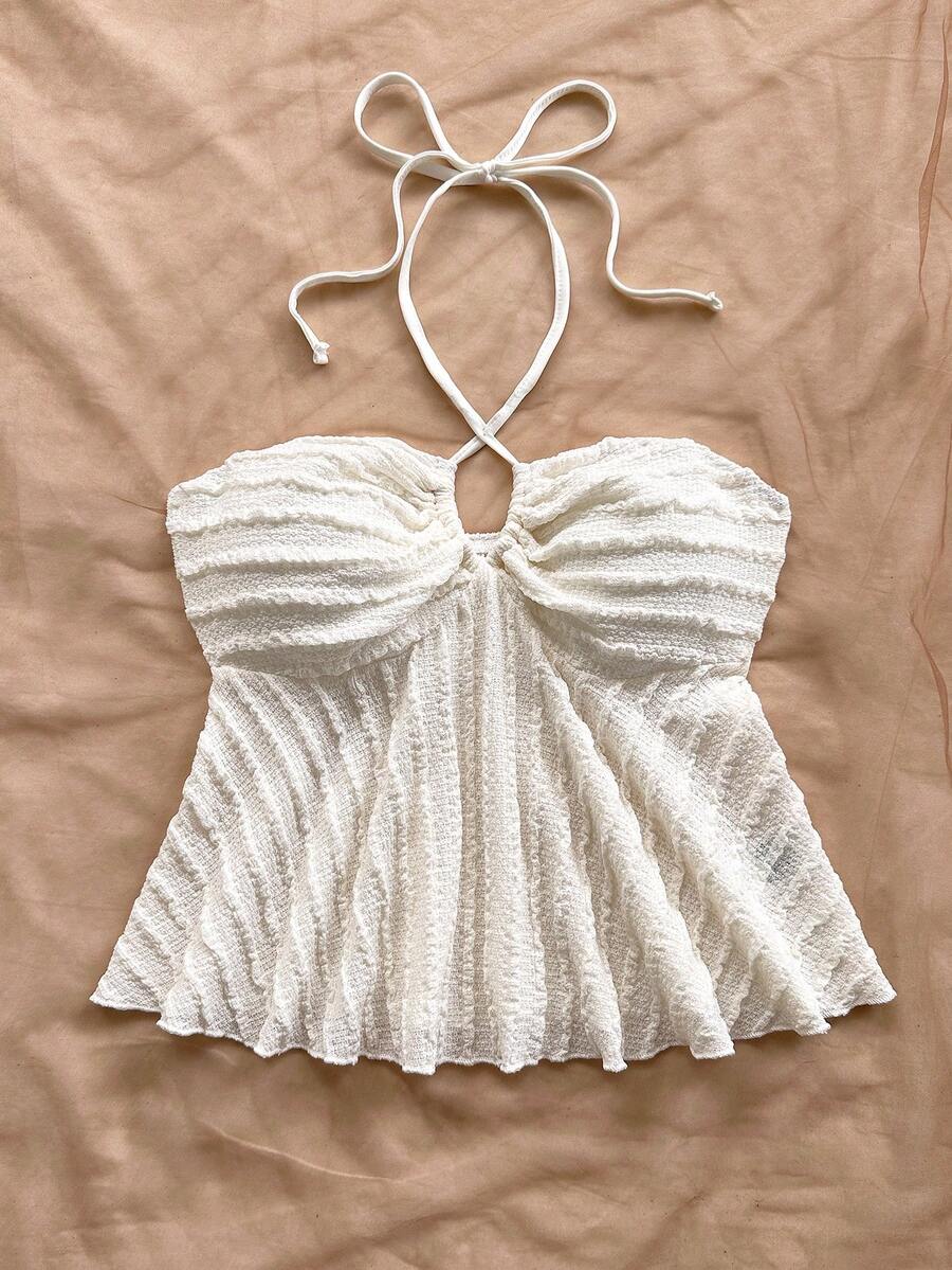 Women's textured V-neck halter tank top with backless knot detail, ruffle hem, and flared silhouette for casual beach and vacation wear.