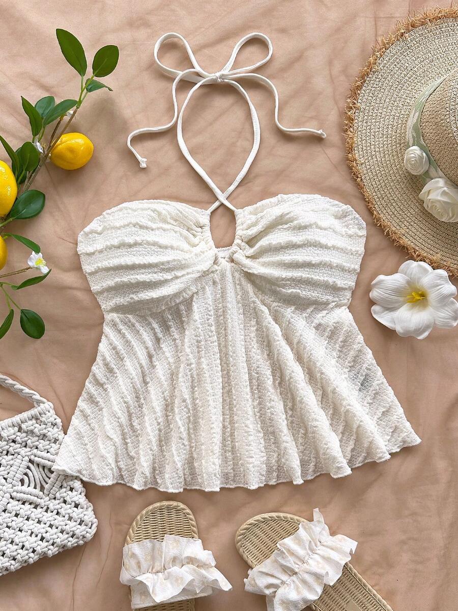 Women's textured V-neck halter tank top with backless knot detail, ruffle hem, and flared silhouette for casual beach and vacation wear.