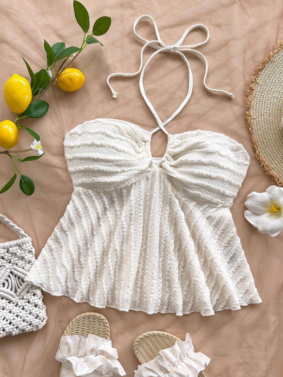 Women's textured V-neck halter tank top with backless knot detail, ruffle hem, and flared silhouette for casual beach and vacation wear.