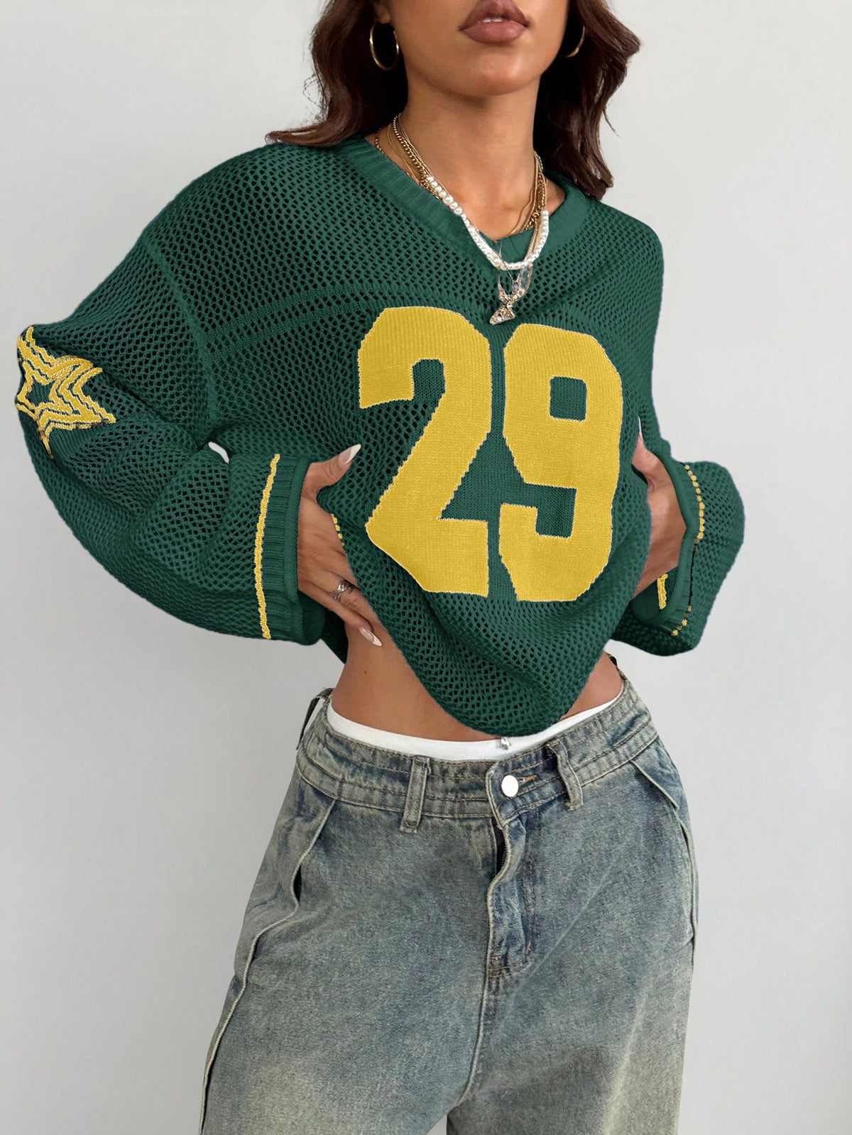 Women's oversized long sleeve knit pullover sweater with round neck, drop shoulder design, and front pocket detail.